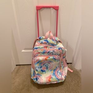 Large rolling backpack. Tie die. Zips closed. 3 large pouches for storage